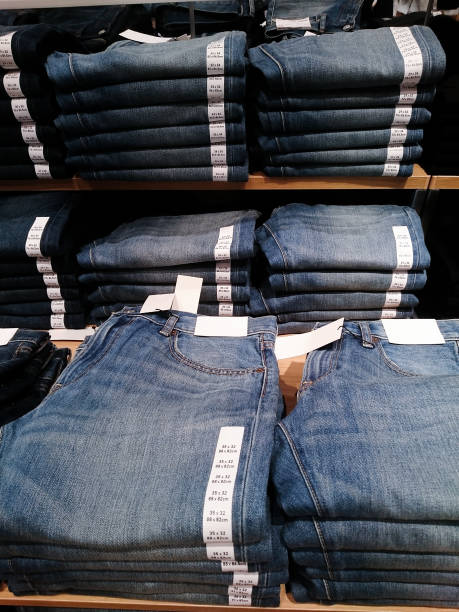 istock Men's pants and jeans on store shelves 1062901068