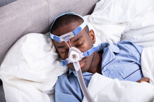 istock Man Wearing CPAP Mask Sleeping On Bed 1062905404