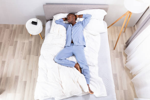 istock High Angle View Of Man Sleeping On Bed 1062905422