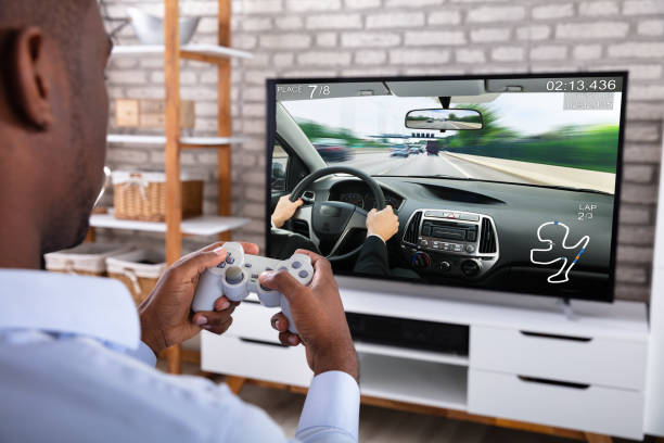 istock African Man Playing Racing Game On Television 1062905604