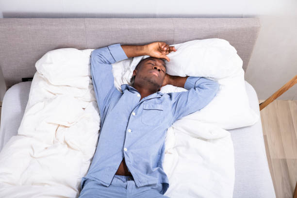 istock High Angle View Of Man Sleeping On Bed 1062905666