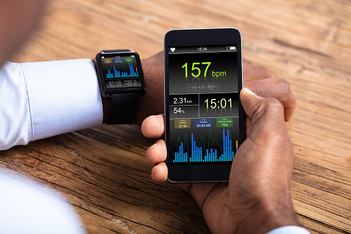 Hombre con Smartwatch y móvil, monitoreo de ritmo cardiaco photo