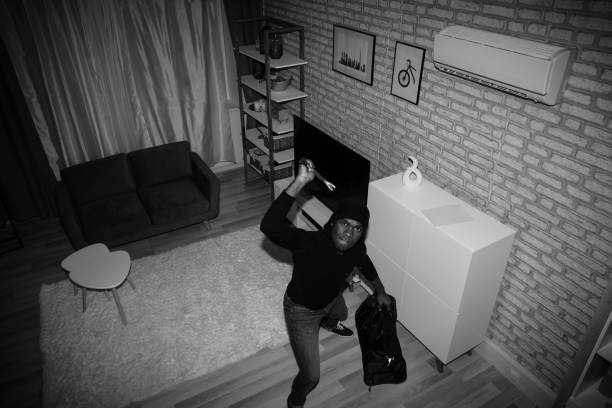 istock Thief With Bag And Crowbar In House 1062907184