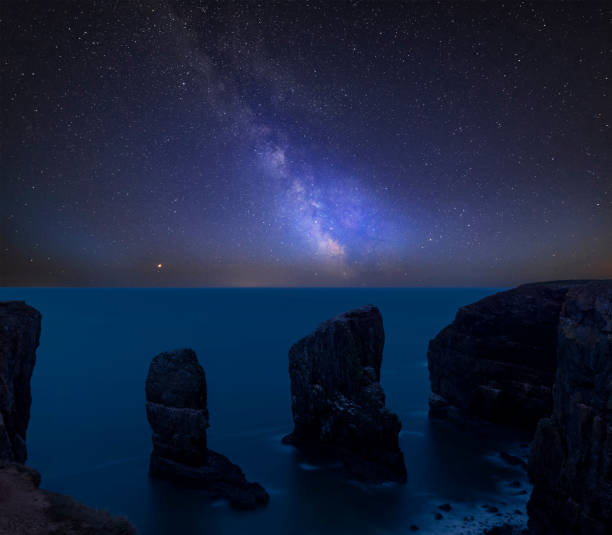 istock Vibrant Milky Way composite image over landscape of Elegug Stacks on Pembrokeshire Coast in Wales 1062907578