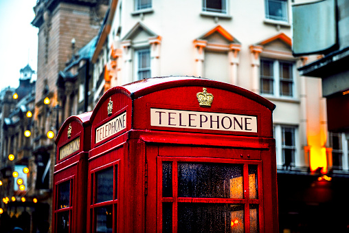 Classic British red colored pay telephone booths  in London, England, UK. Horizontal composition.