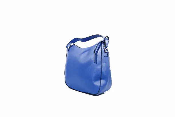 Photo of Empty blue ladies handbag isolated on white background