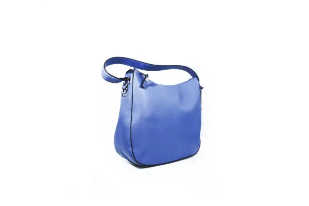 Photo of Empty blue ladies handbag isolated on white background