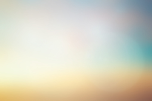abstract blurred early sunlight of teal and gold color sky background with lens flare light for design element as banner , presentation