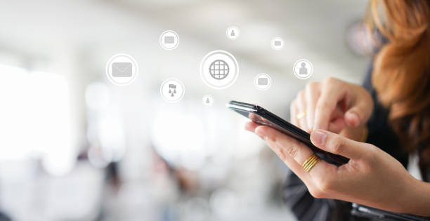 close up businesswoman hand holding smartphone touch screen on display for checking work with virtual reality interface for future technology concept
