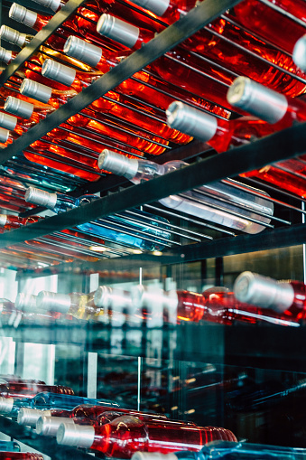 Detail image of Metal rack with plenty of wine bottles composed in rows for decor.