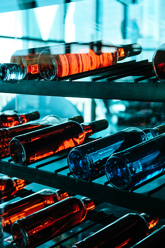 Detail image of Metal rack with plenty of wine bottles composed in rows for decor.