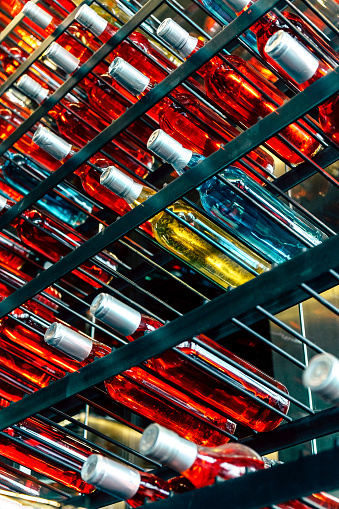 Detail image of Metal rack with plenty of wine bottles composed in rows for decor.