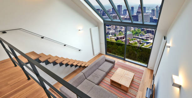 istock Modern living room with large windows and view on city panorama 1062924116