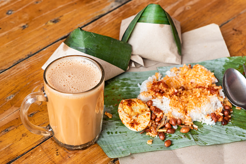 Simple banana leaf nasi lemak and teh tarik breakfast, popular breakfast in Malaysia
