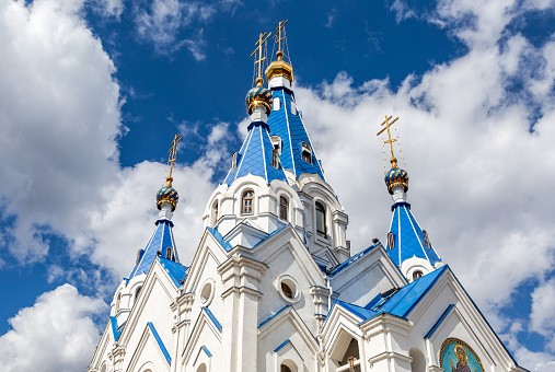 Blue and golden domes of Church of the Nativity of the Blessed Virgin against the blue sky in Samara, Russia