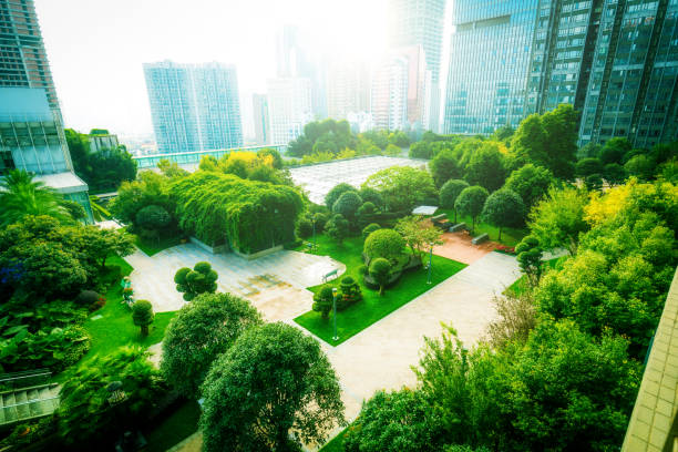 istock Office buildings with green city park trees 1062930154
