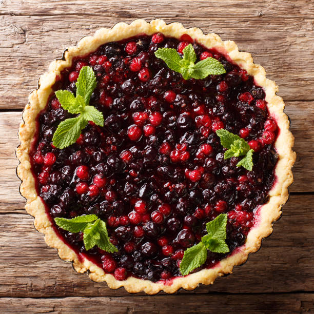 istock Summer dessert: tart with currant berries, blueberries and cranberries close-up in a baking dish. top view from above 1062932806