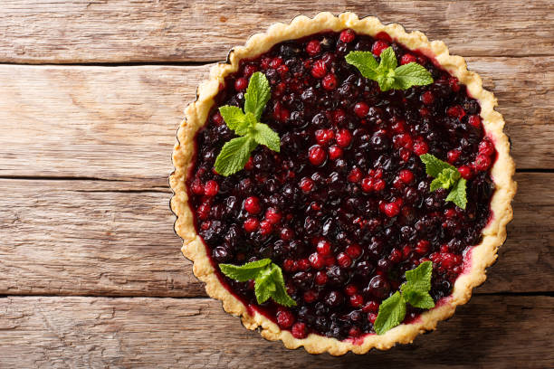 istock Homemade pie with summer berries and mint closeup in a baking dish. Horizontal top view from above 1062932970