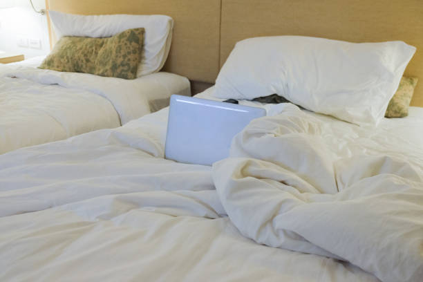 istock Bed working space with laptop in hotel 1062933196