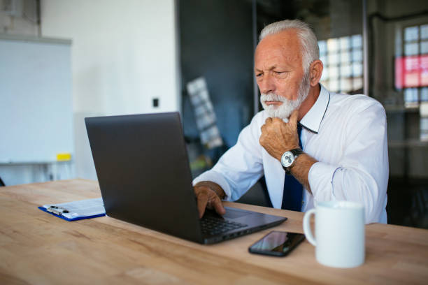 istock Senior businessman using laptop at the office 1062935286