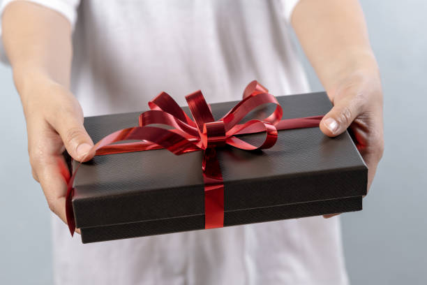 istock Woman hand holding gift box 1062936820