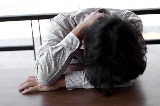 istock Disappointed stressed young Asian business man bend down head. 1062939188