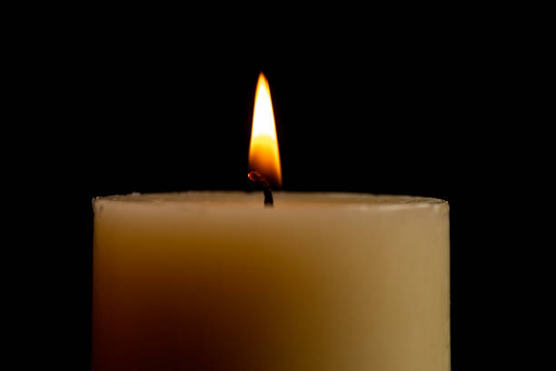 istock Candle With Flame With The Dark Black Background 1062939276