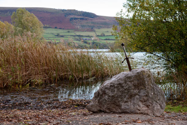 Sword in the Stone Excalibur the famous sword in the stone of king Arthur in the forest, Llangorse Lake, Brecon Beacons excalibur stock pictures, royalty-free photos & images