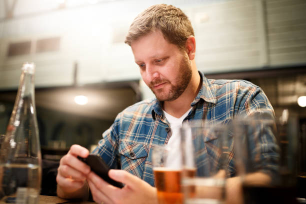 istock Man checking his smart phone at restaurant 1062943544