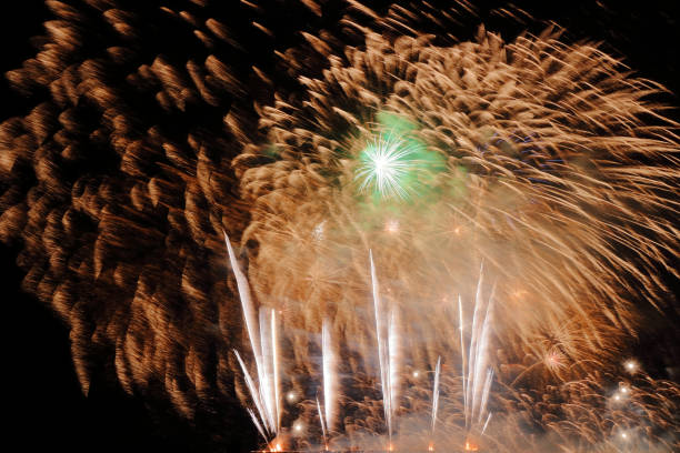 istock Festive colorful fireworks on night sky background. Celebratory holiday 1062944318