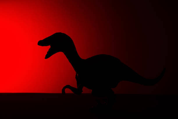 Toy Dinosaur Holding A Tomato In Its Mouth