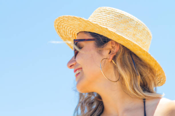istock Young summer woman wearing hat and sunglasses at the beach 1062951334