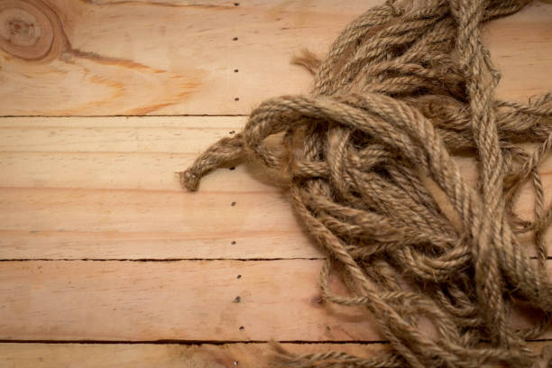 Aged rope on the old wooden pattern background