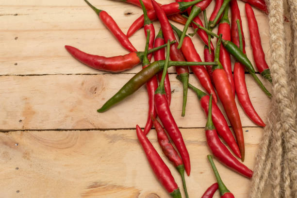 istock Red Hot Chili Peppers over wooden background. 1062956580
