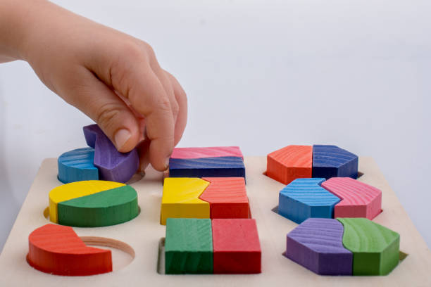 istock Colorful pieces of a logic puzzle in hand 1062959346