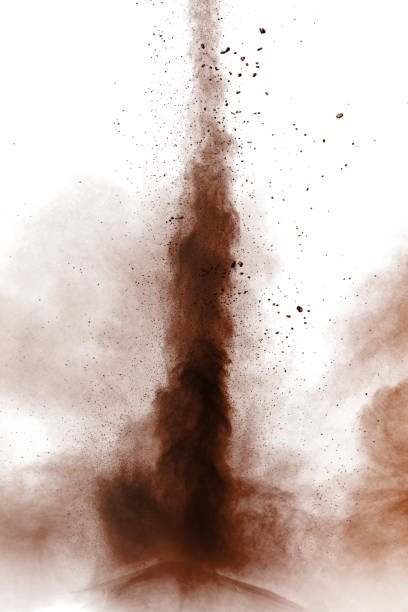 istock coco color particles splatter on white background. Deep brown dust splash on white background. 1062965032