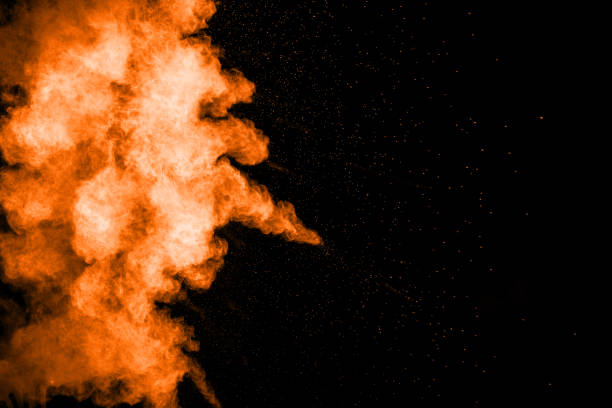 istock orange dust particles explosion on black background. Color powder dust splash. 1062965332