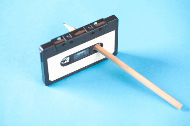 istock cassette and pencils  on blue table background 1062965804