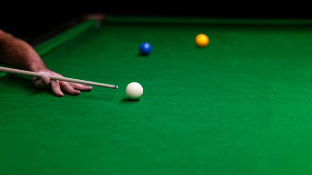 istock Player hand with the cue and balls on a green cloth 1062969524