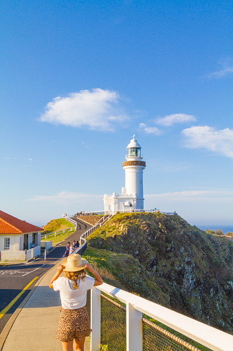 Byron Bay, NSW, Australia - October 29, 2018: People enjoying the sunny weather on the Byron Bay's lighthouse, a popular destination with beaches and coastal trails on the North Coast of NSW, Australia.