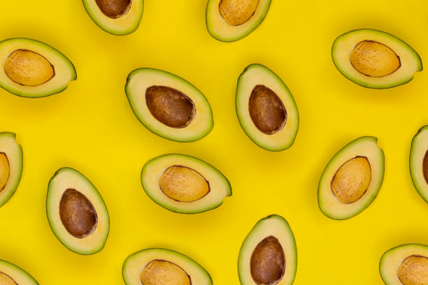 istock Avocado on the yellow background. Top view 1062983074