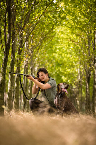 Autumn hunting season. Hunting. Outdoor sports. Woman hunter in the woods