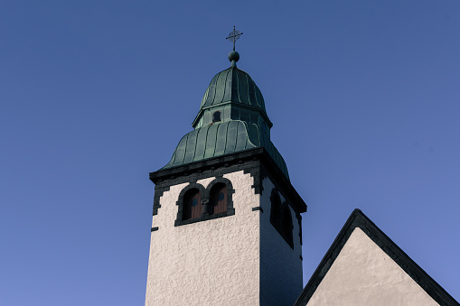 Tower of the 17th-century Dom St. Stephan (St. Stephen's Cathedral) in Passau, Germany, seen against a blue sky on a sunny day.