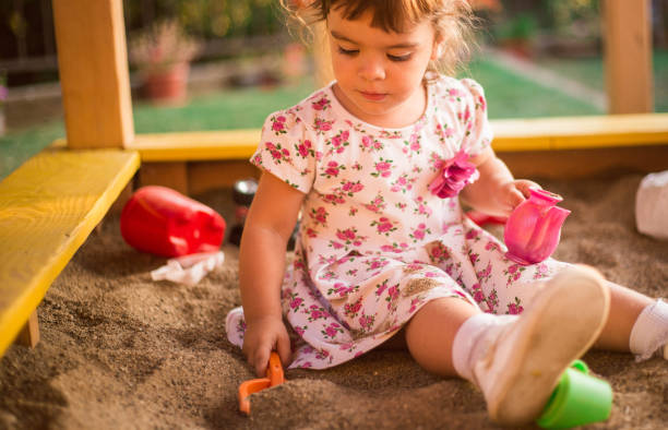istock Little Girl Playing At Playground Outdoors In Summer 1062989222