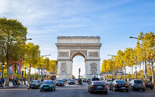 Paris, France - September 29, 2018: Pedestrian view on traffic road of Champs-Elysess to Arc de Triomphe, built to honour the victories of Napoleon Bonaparte.