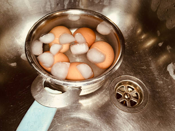 cooling down freshly boiled eggs stock photo