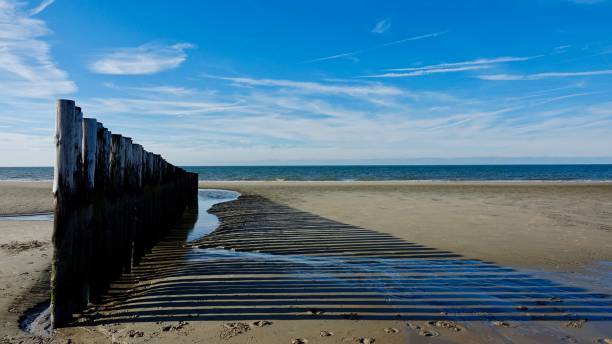 istock Wooden wave breaker at a beach 1062997996