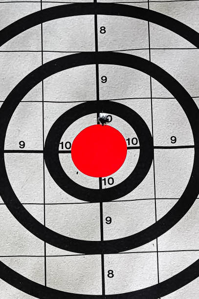 istock Closeup of a target bullseye with a bullet hole 1062999532