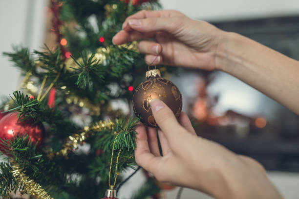 istock Closeup of female hands decorating Christmas tree 1063003014