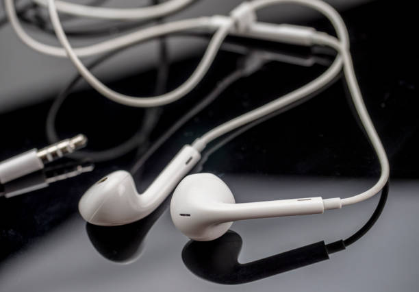 istock White headphones isolated on black background, conceptual image 1063009566